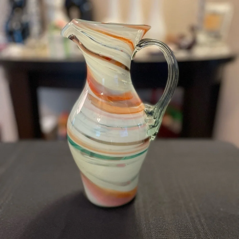 Vintage hand blown art glass swirl pitcher with applied handle.